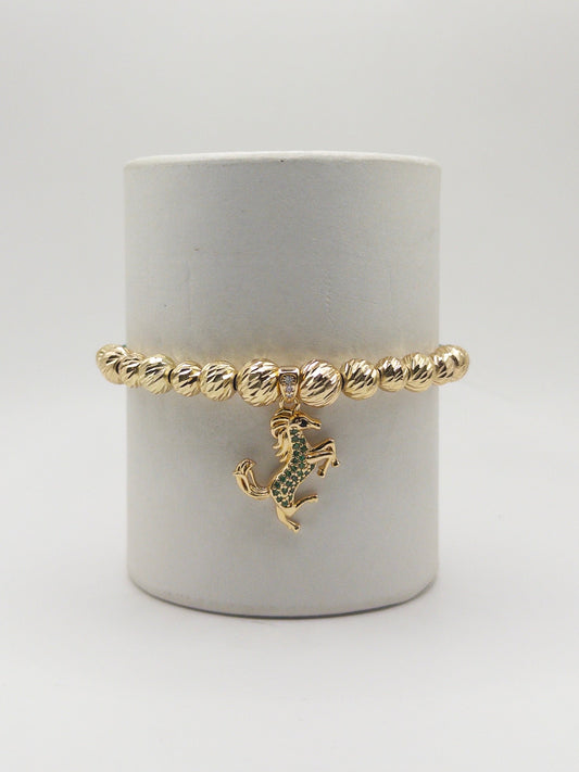 TEJIDA DIJE EQUINO VERDE ORO LAMINADO 18K